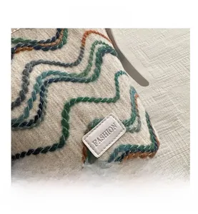 Close-up of bohemian weave patterns and stitched leather fashion label on a bucket bag