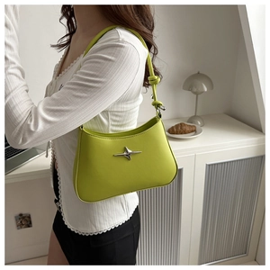 Detail of bright green underarm bag featuring a silver star buckle and knotted strap