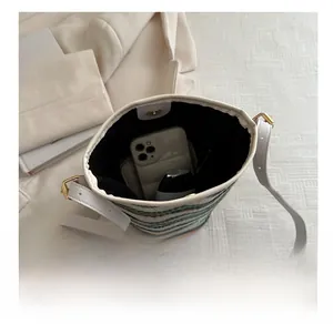 Top view of striped woven bucket bag showing large interior capacity and magnetic closure