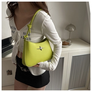 Detail of avocado green underarm bag with silver star and knotted shoulder strap detail