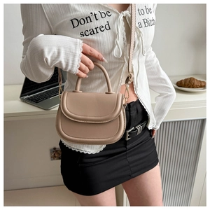 Detail view of beige small flap square bag showing fine stitching and PU leather texture