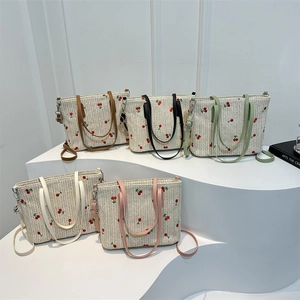 Large woven straw tote bag with cherry embroidery and colorful straps for summer