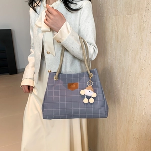 Blue-grey plaid tote bag with woven handles and plush pendant for office use