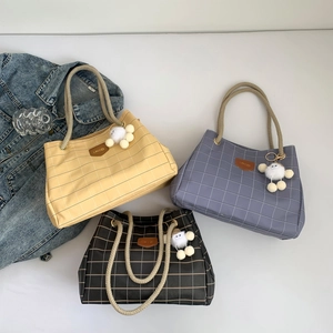 Plaid pattern tote bags with rope handles and plush pom-pom charms in three colors