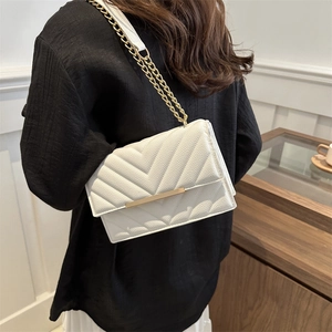 White chevron quilted crossbody bag with gold hardware and elegant chain strap for women