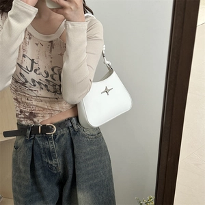 Minimalist white hobo shoulder bag with silver star charm shown in a mirror selfie
