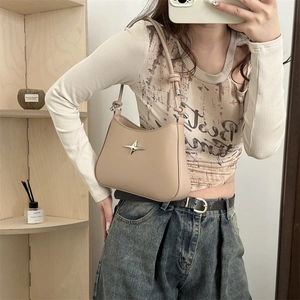 Chic beige half-moon underarm bag with silver star ornament and knotted strap detail
