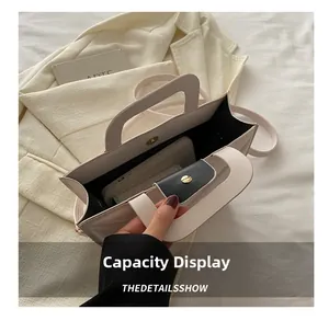 Internal view of cream tote bag showing large capacity for phone and wallet with magnetic snap