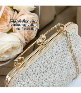 Detail of elegant gold metal frame and double ball clasp on a straw woven bag