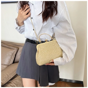 Straw seashell bag with gold chain strap styled on a minimalist casual summer outfit