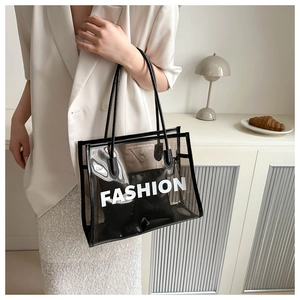 Close-up of black transparent PVC tote with Fashion lettering and inner pouch