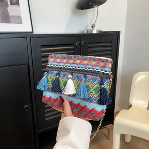 Bohemian woven crossbody bag with colorful geometric patterns and decorative tassels