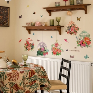 Colorful birdcage and butterfly wall decals with life is wonderful text on a cream wall