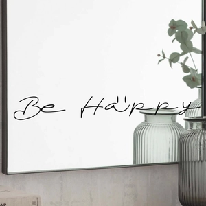 Detail of Be Happy black motivational quote decal with smiley face on a bathroom mirror