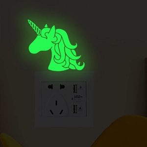 Glow-in-the-dark unicorn light switch sticker emitting a bright green neon light