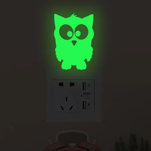 Glow in the dark cartoon owl wall sticker emitting green light around light switch