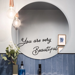 Detail of 'You are very Beautiful' black script wall decal on a bathroom mirror surface