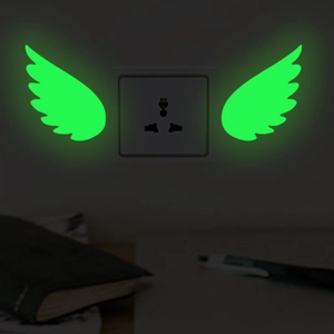 Luminous green wing-shaped stickers for wall or light switch decoration in dark rooms