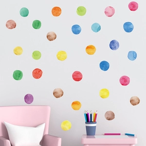 Nursery wall with watercolor polka dot stickers in pastel tones for child room decor