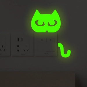 Glow in the dark cat wall sticker showing luminous green fluorescent light effect