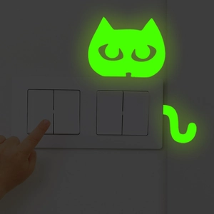 Glow-in-the-dark cat wall stickers for light switches emitting green fluorescent light