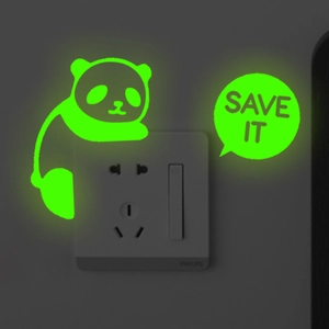 Luminous panda wall sticker with Save It slogan glowing in the dark near light switch