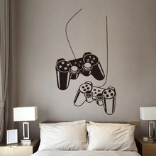 Creative game controller wall stickers displayed above a bed in a modern bedroom