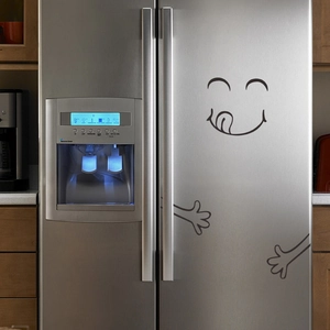 Funny smiling face with arms creative sticker on a stainless steel refrigerator door