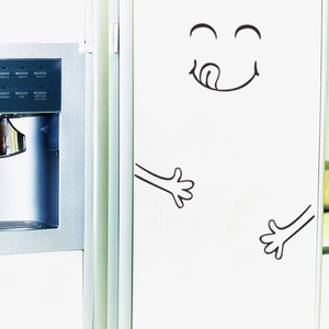 Funny fridge sticker with creative smiling face and open arms on white kitchen cabinet