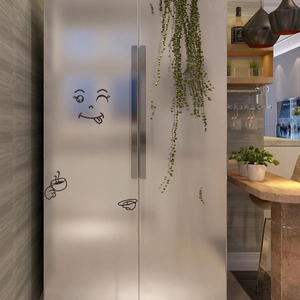 Funny cartoon face vinyl sticker with coffee cup detail on silver refrigerator