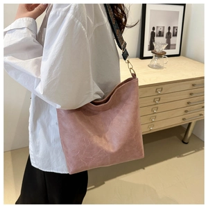 Detail of dusty pink tote bag with colorful ethnic style woven wide shoulder strap