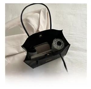 Détail montrant la grande capacité intérieure de ce cabas minimaliste noir en similicuir