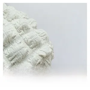 Macro view of high-quality white bubble textured fabric with detailed 3D pleated surface
