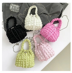 Collection of quilted bubble mini bucket bags in five vibrant colors with silver chains