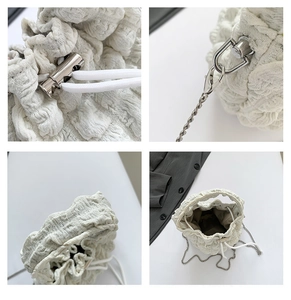 Detail view of white bubble texture fabric and metal drawstring closure on bucket bag