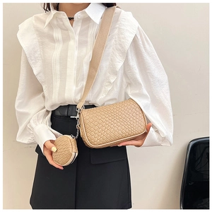 Detail of woven texture beige crossbody bag set with a round hanging coin purse