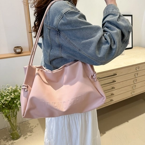 Minimalist light pink leather tote bag with embossed letters and knot detail for women
