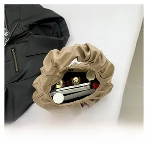 Interior view of beige cloud tote bag showing large capacity for phone and cosmetics