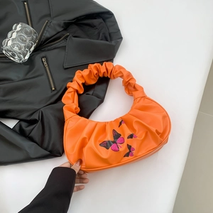 Orange pleated cloud handle underarm bag with butterfly print and crescent shape