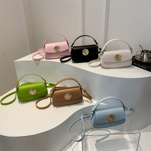 Minimalist square underarm bags with gold shell-shaped hardware in six vibrant colors