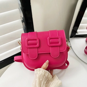 Fuchsia pink saddle shoulder bag with decorative square buckles and leather strap