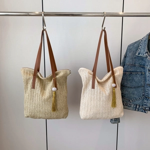 Large woven tote bag with tassels and leather handles in khaki and cream white tones