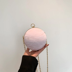 Chic pink sphere clutch bag with pleated texture, gold ring handle and chain strap