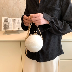 Chic white marble spherical chain bag with gold circular handle and metal strap