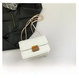 Quilted white crossbody bag size comparison with a smartphone showing its compact mini scale