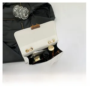 Top view of white quilted crossbody bag showing inner capacity for phone and cosmetics
