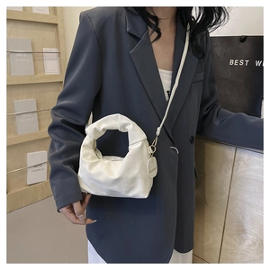 White ruched cloud bag shown in a stylish side-carry view with a delicate metal hook