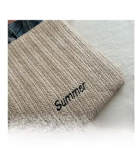 Detail view of woven straw tote bag with black embroidered Summer text for holiday style