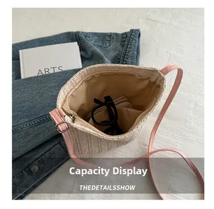 Detail view of woven straw bag interior with zipper closure and essential items