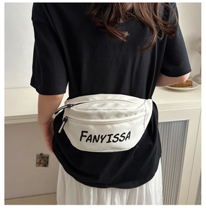 Detailed back view of white nylon shoulder bag with FANYISSA print in a lifestyle setting